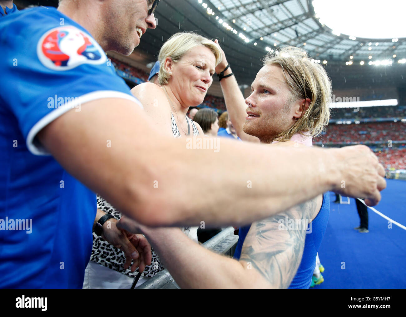 Iceland's Birkir Bjarnason celebrates with his family after the Euro 2016, Group F match at the Stade de France, Paris. PRESS ASSOCIATION Photo. Picture date: Wednesday June 22, 2016. See PA story SOCCER Iceland. Photo credit should read: Owen Humphreys/PA Wire. RESTRICTIONS: Use subject to restrictions. Editorial use only. Book and magazine sales permitted providing not solely devoted to any one team/player/match. No commercial use. Call +44 (0)1158 447447 for further information. Stock Photo