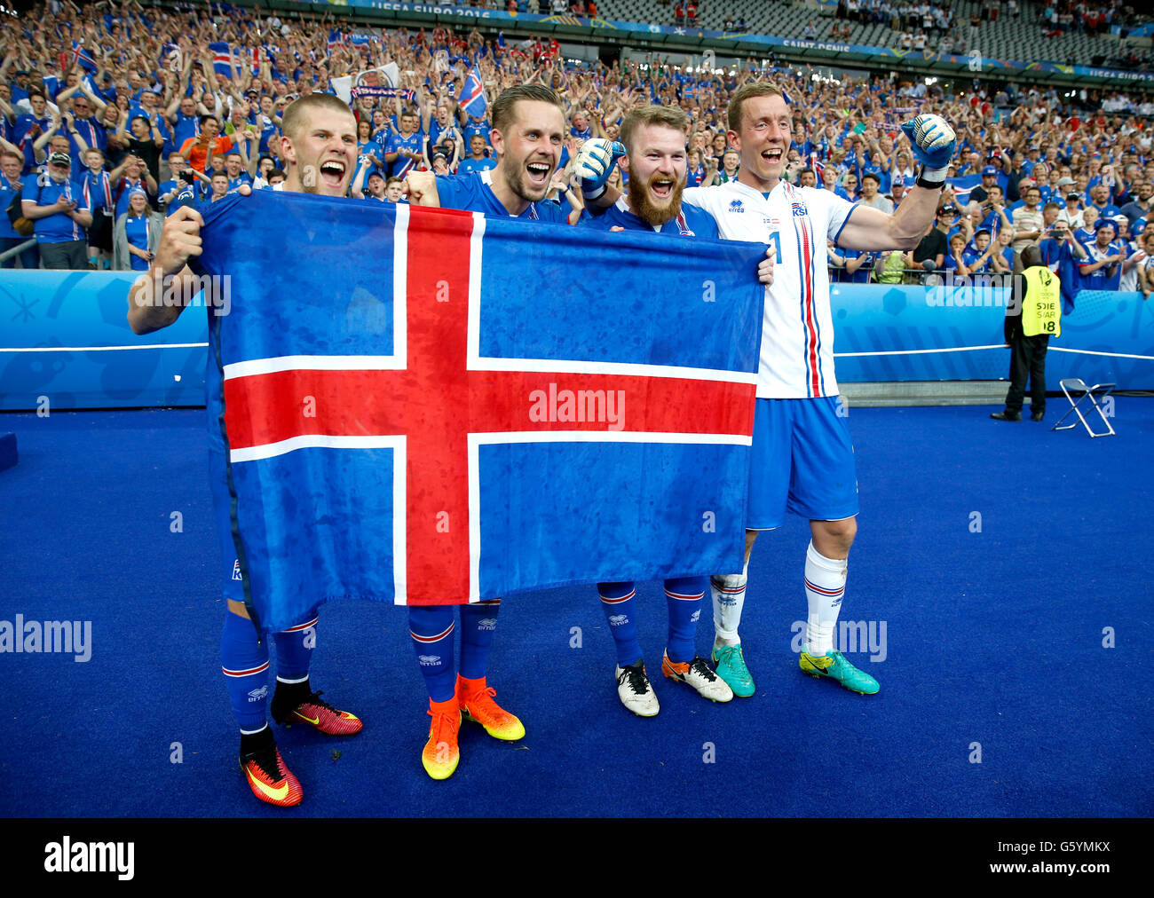 (left to right) Iceland's Johann Berg Gudmundsson, Gylfi Sigurdsson, Aron Gunnarsson and Hannes Halldorsson celebrate qualifying for the last 16 round after the Euro 2016, Group F match at the Stade de France, Paris. Stock Photo