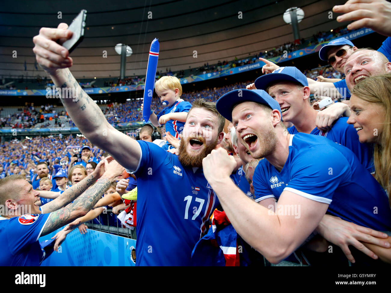 Iceland's Aron Gunnarsson celebrates with a fan selfie after qualifying for the last 16 round after the Euro 2016, Group F match at the Stade de France, Paris. Stock Photo