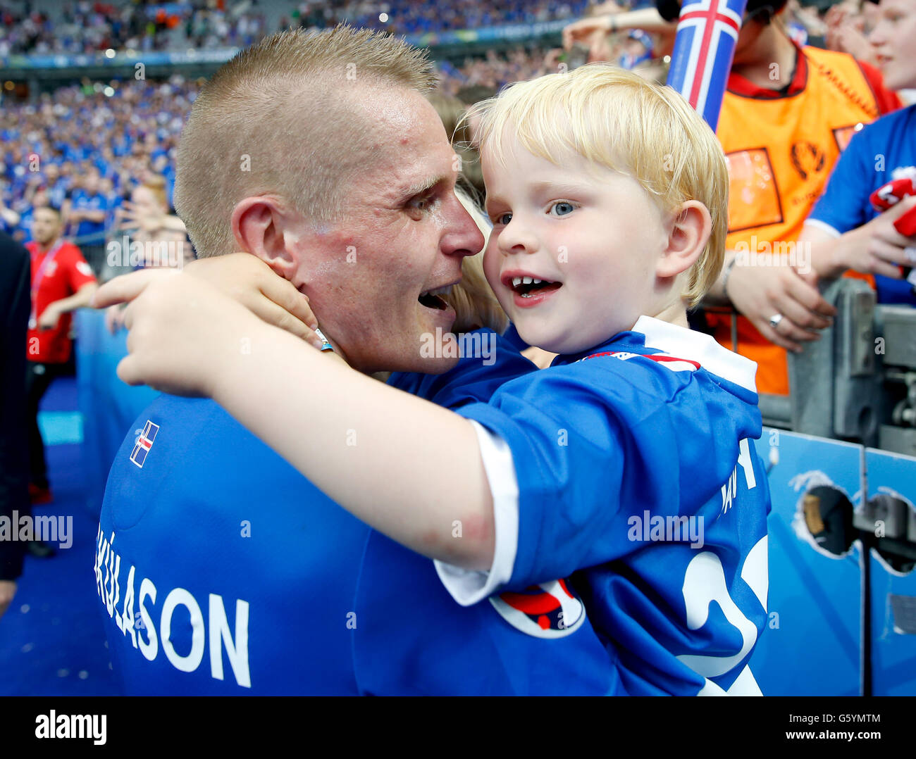 Iceland's Ari Freyr Skulason celebrates qualifying for the last 16 round with his Son after the Euro 2016, Group F match at the Stade de France, Paris. Stock Photo