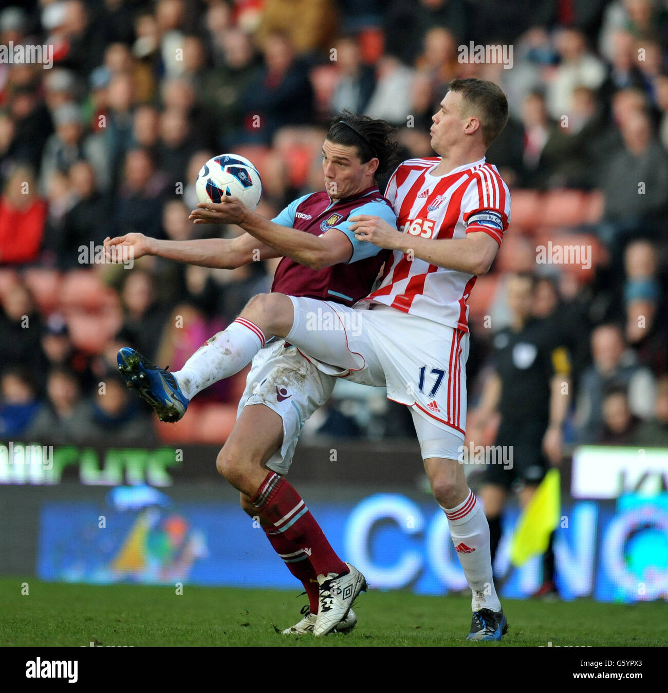Stoke City's Ryan Shawcross challenges West Ham United's Andy Carroll during the Barclays Premier League match at the Britannia Stadium, Stoke. Stock Photo