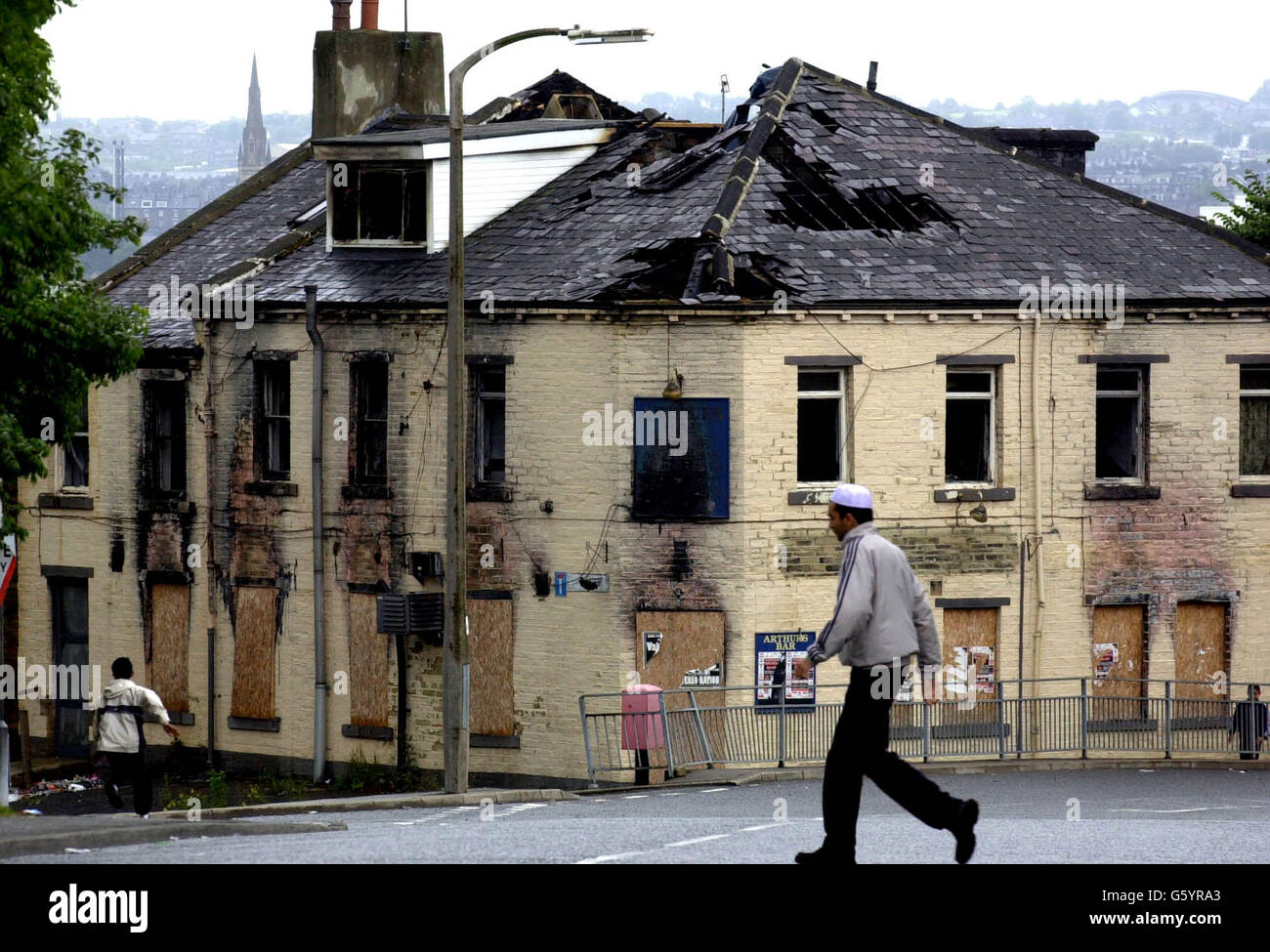 One year on from the Bradford riots which took place over the coming weekend, many areas of this West Yorkshire city still show the scars of the violence such as this burned out pub known as Arthurs Bar, in the Manningham area of Bradford, which still remains gutted and empty. Stock Photo