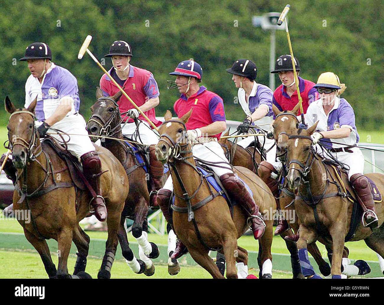 Prince Harry (second left), Prince Charles (centre) and Prince William (second right) playing for Highgrove against Cirencester Park in The ladbrokes.com Trophy at Cirencester Park Polo Club. Highgrove beat Cirencester Park. Stock Photo