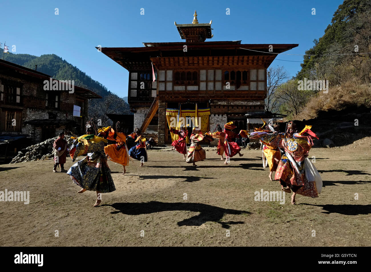 Masked dancers taking part in a rare and old sacred dance called Zhey not performed elsewhere in Bhutan during the annual religious Bhutanese Tshechu festival in Ngang Lhakhang a Buddhist monastery also known as the 'Swan temple' built in the 16th century by a Tibetan lama named Namkha Samdrip in the Choekhor Valley of Bumthang District central Bhutan Stock Photo