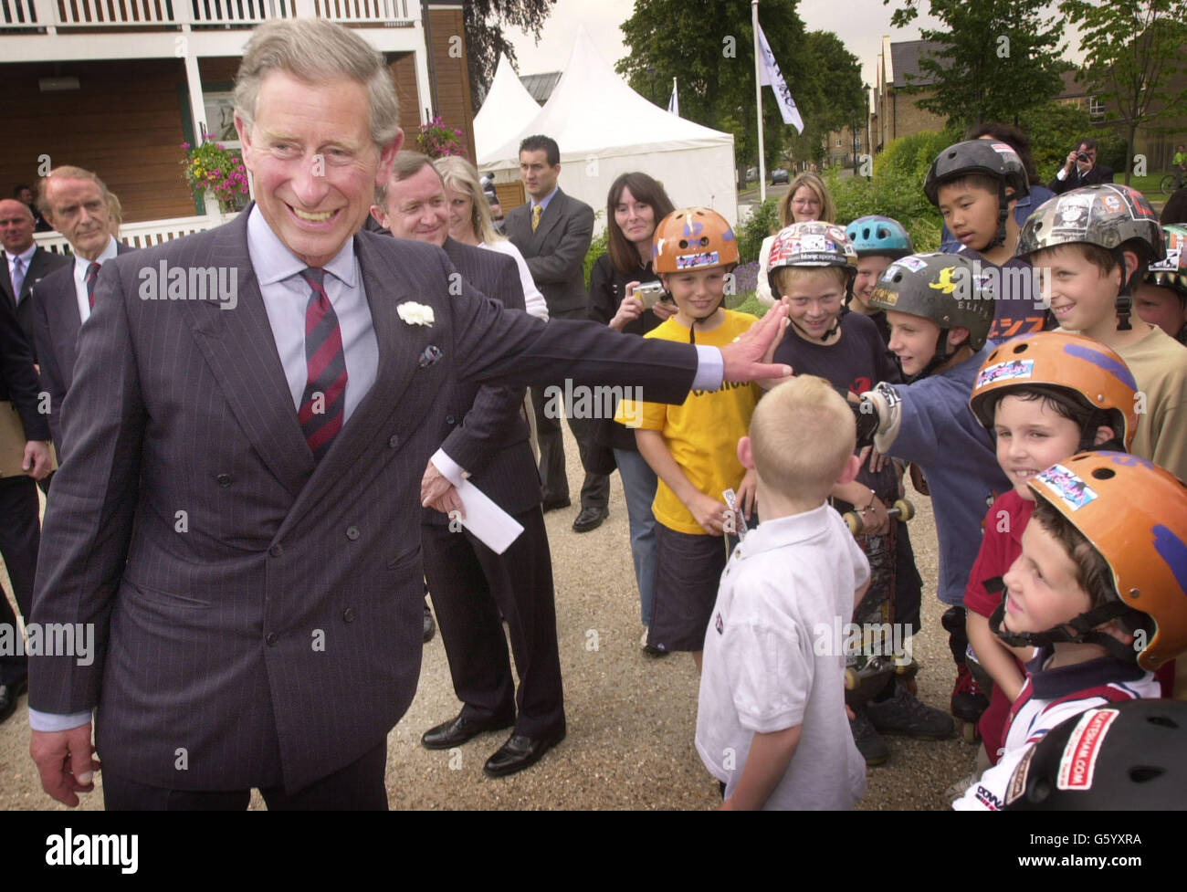 The Prince Of Wales meets children at 'The Village' in Caterham, Surrey, an army barracks which has been converted into a housing estate by the Guinness Trust, a charitable housing association of which the Prince is patron. *The 60 million mixed development has 96 affordable homes - for key workers and others on low incomes - and 252 for private sale, said a trust spokeswoman. Stock Photo