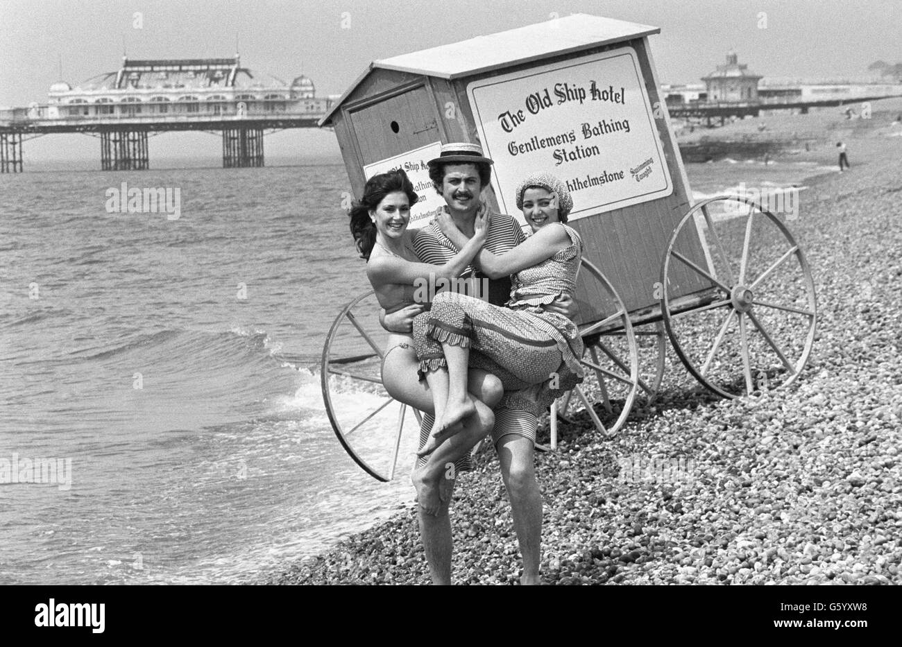 Brighton remembers its Regency heritage, helped by Nigel Phillips, Brighton belle Tracey Gunn, dressed in Regency outfit (r), and the new Miss Brighton Frances Clarke. The three posed in front of an old-fashioned bathing machine on the beach of the famous south coast resort. Stock Photo