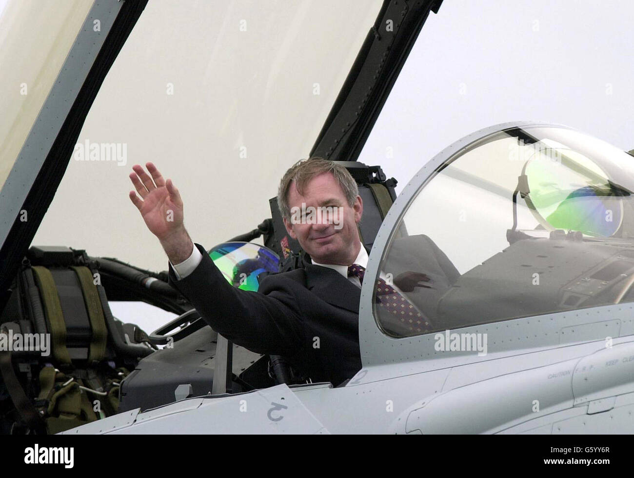 Defence Minister Geof Hoon seated in the Typhoon which he officially named. Four RAF Eurofighters fly over Farnborough Airshow in a display before the plane was officically named Typhoon by Mr Hoon. The first Typhoon is due to be delivered to the RAF by the end of this year. *....Mr Hoon, accompanied by the Chief of the Air Staff, Air Chief Marshall Sir Peter Squire and the Chief of Defence Procurement, Sir Robert Walmsley, met Typhoon's air crew, Craig Penrice and Wing Commander David 'Charlie' Chan after the formation flypast. Stock Photo