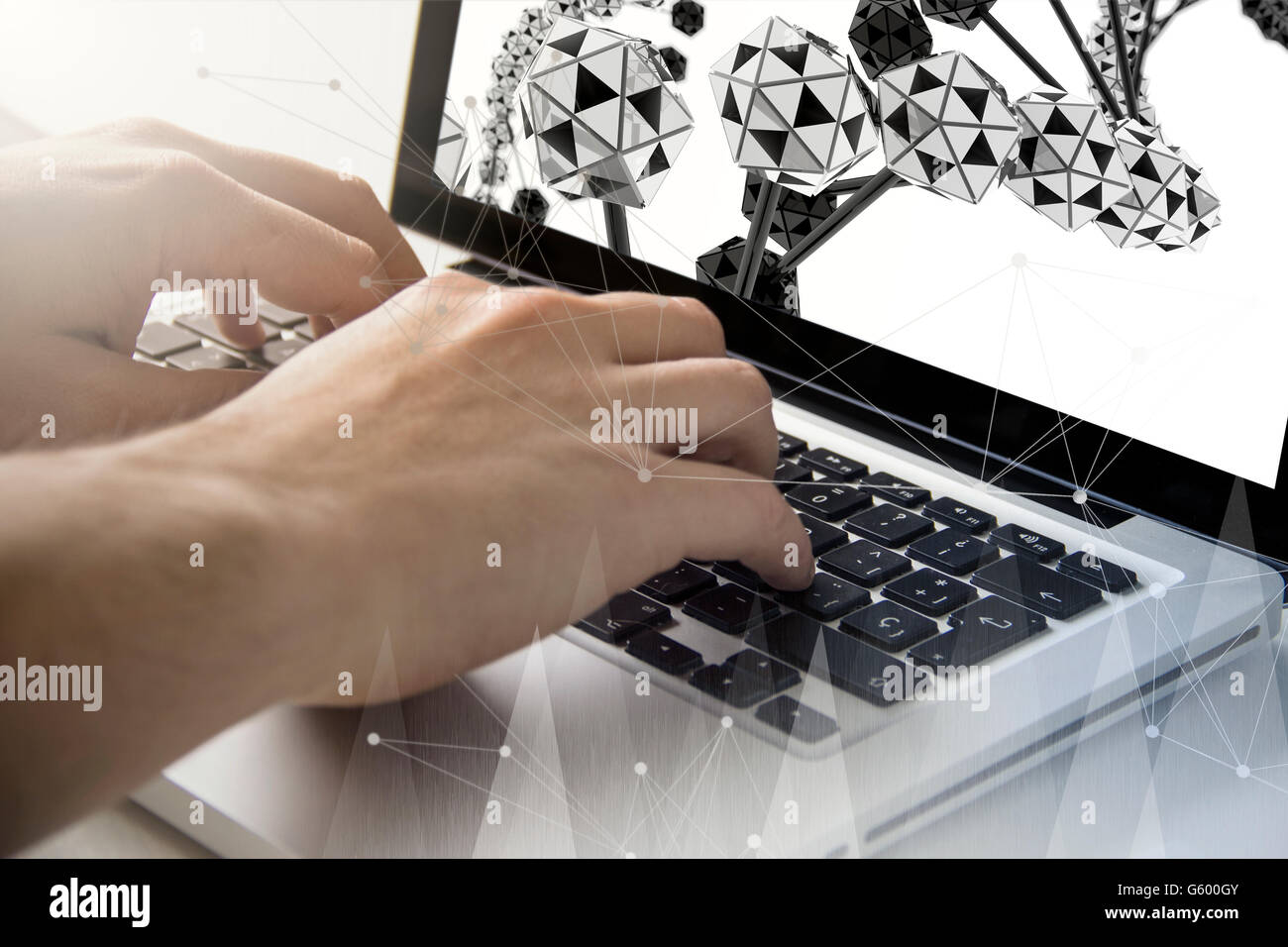 technology and medical concept: man using a laptop with dna chains on the screen. All screen graphics are made up. Stock Photo