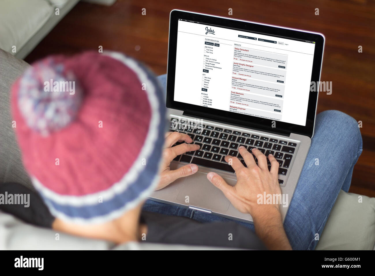 Applicant browsing job application. All screen graphics are made up. Stock Photo