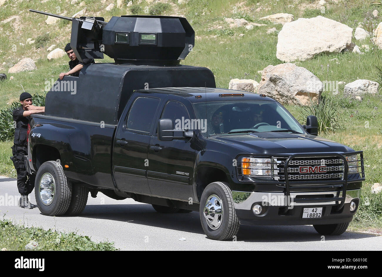Gmc suv with mounted machine gun protects prince charles hires stock