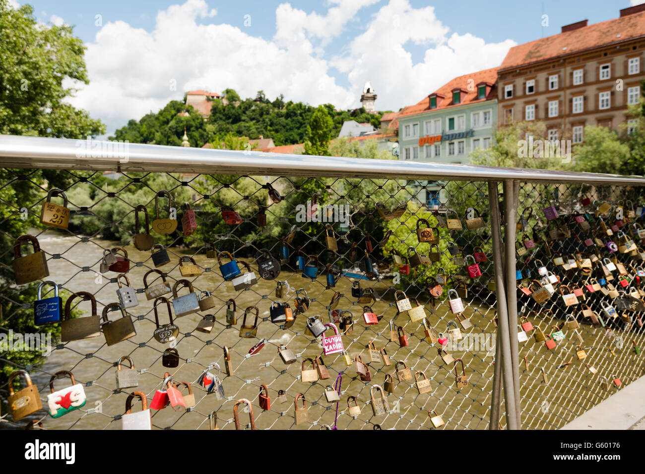Graz, Austria - June 18, 2016: View over a bridge full of love lockers to  the old clock tower on Schlossberg, castle hill, in Gr Stock Photo - Alamy