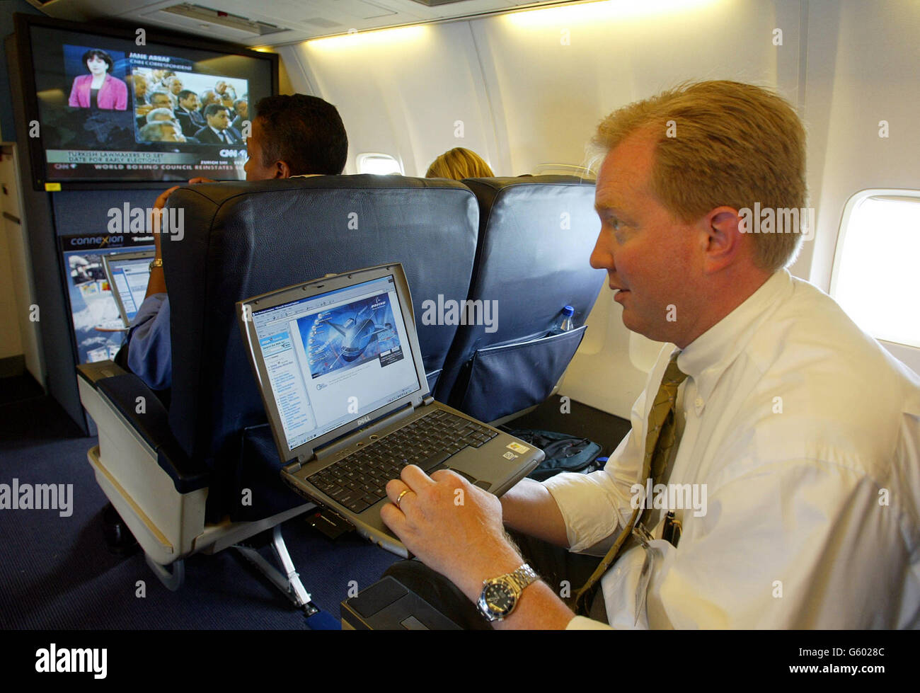 Stan Deal, Director of Commercial Sales for Connexion by Boeing surfs broadband internet while flying at 5,000 ft over London on one of the company's 737 jets. Stock Photo