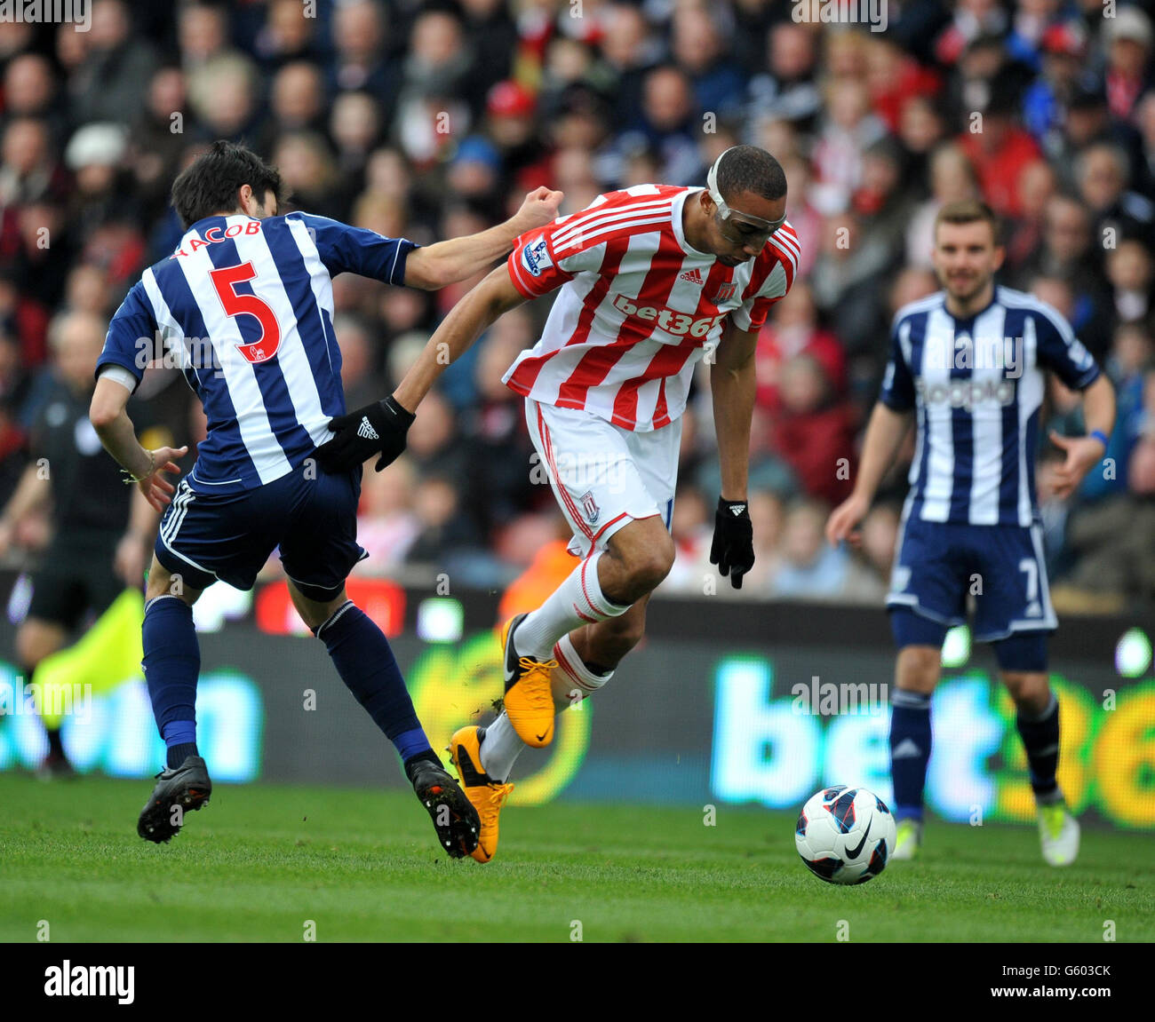 Stoke City's Steven Nzonzi goes past West Bromwich Albion's Claudio Yacob during the Barclays Premier League match at the Britannia Stadium, Stoke. Stock Photo