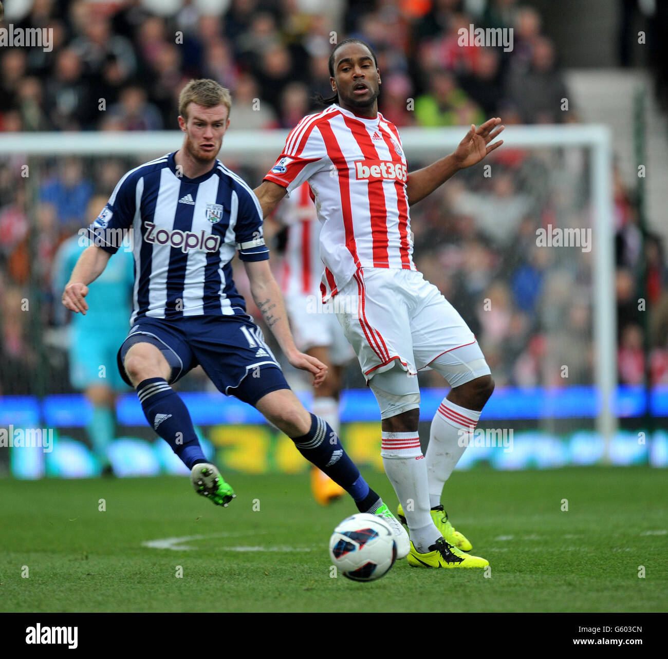 West Bromwich Albion's Chris Brunt and Stoke City's Cameron Jerome (right) during the Barclays Premier League match at the Britannia Stadium, Stoke. Stock Photo