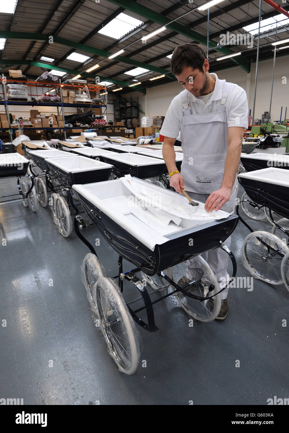 Jamie Kenworthy inserts the bed into a Balmoral pram at the Silver Cross  Factory, Keighley, West Yorkshire Stock Photo - Alamy