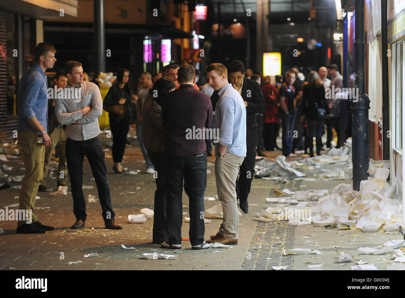 Revellers enjoy a Saturday night out on Caroline Street, commonly known as Chip Alley in Cardiff city centre. Stock Photo