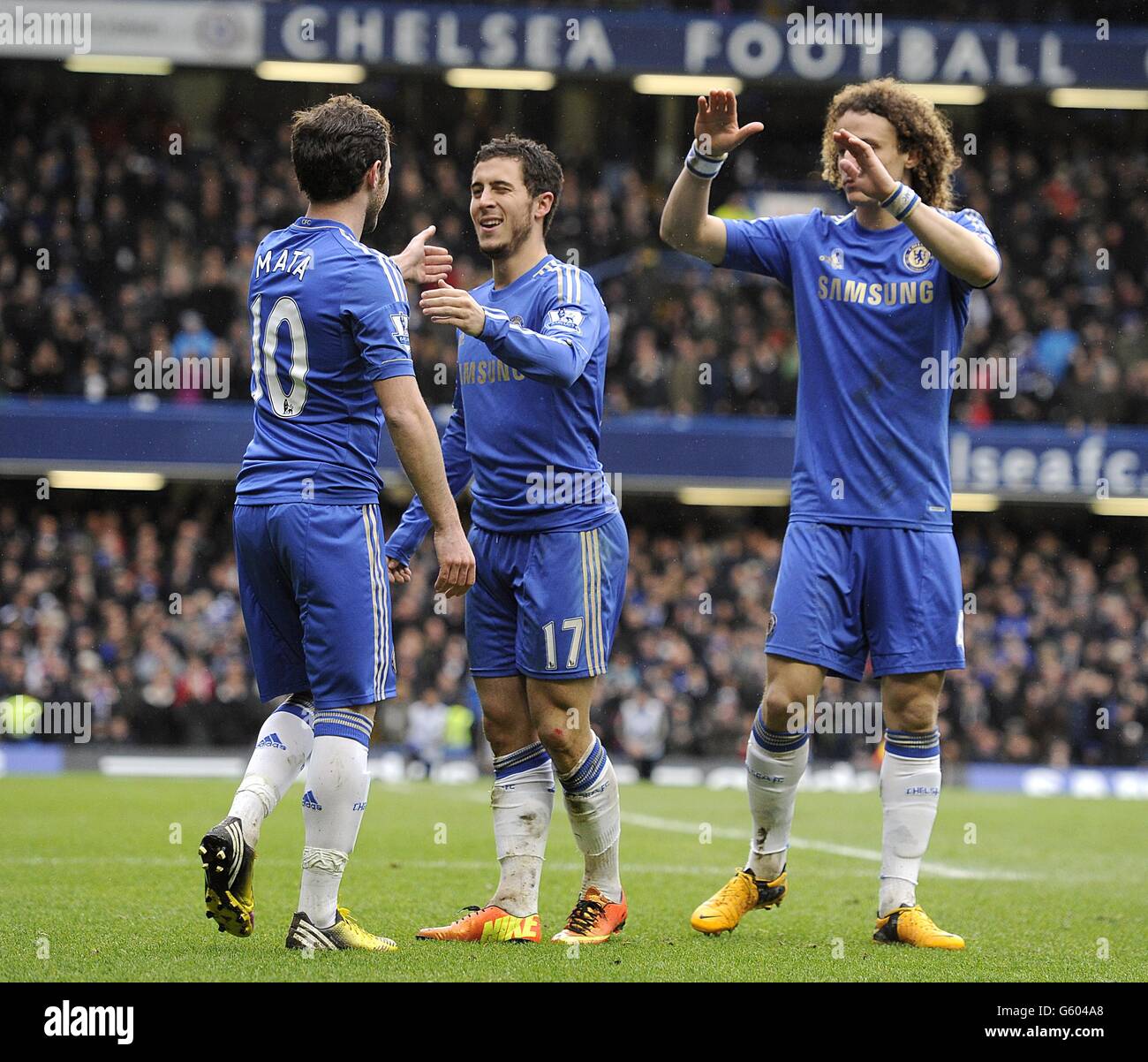 Chelsea's Eden Hazard (centre) celebrates with his team-mates David Luiz (right) and Juan Mata (left) after scoring his team's second goal Stock Photo