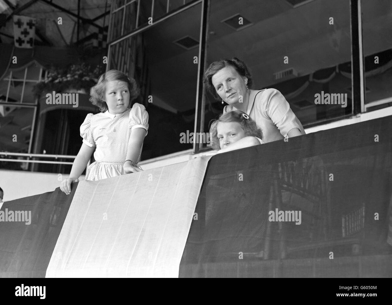 Queen Juliana of the Netherlands and her daughters Princess Beatrix and Princess Irene watch the riding at the International Horse Show in White City, London. Stock Photo