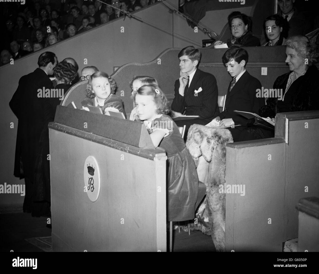 Princess Beatrix (left) and Princess Irene, daughters of Queen Juliana and Prince Bernhard of the Netherlands, watch the Bertram Mills Circus at Olympia in London. Stock Photo