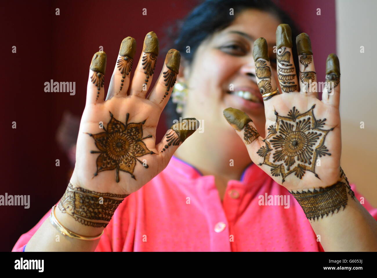 beautiful indian married lady showing henna design on her hands MODEL RELEASE Stock Photo