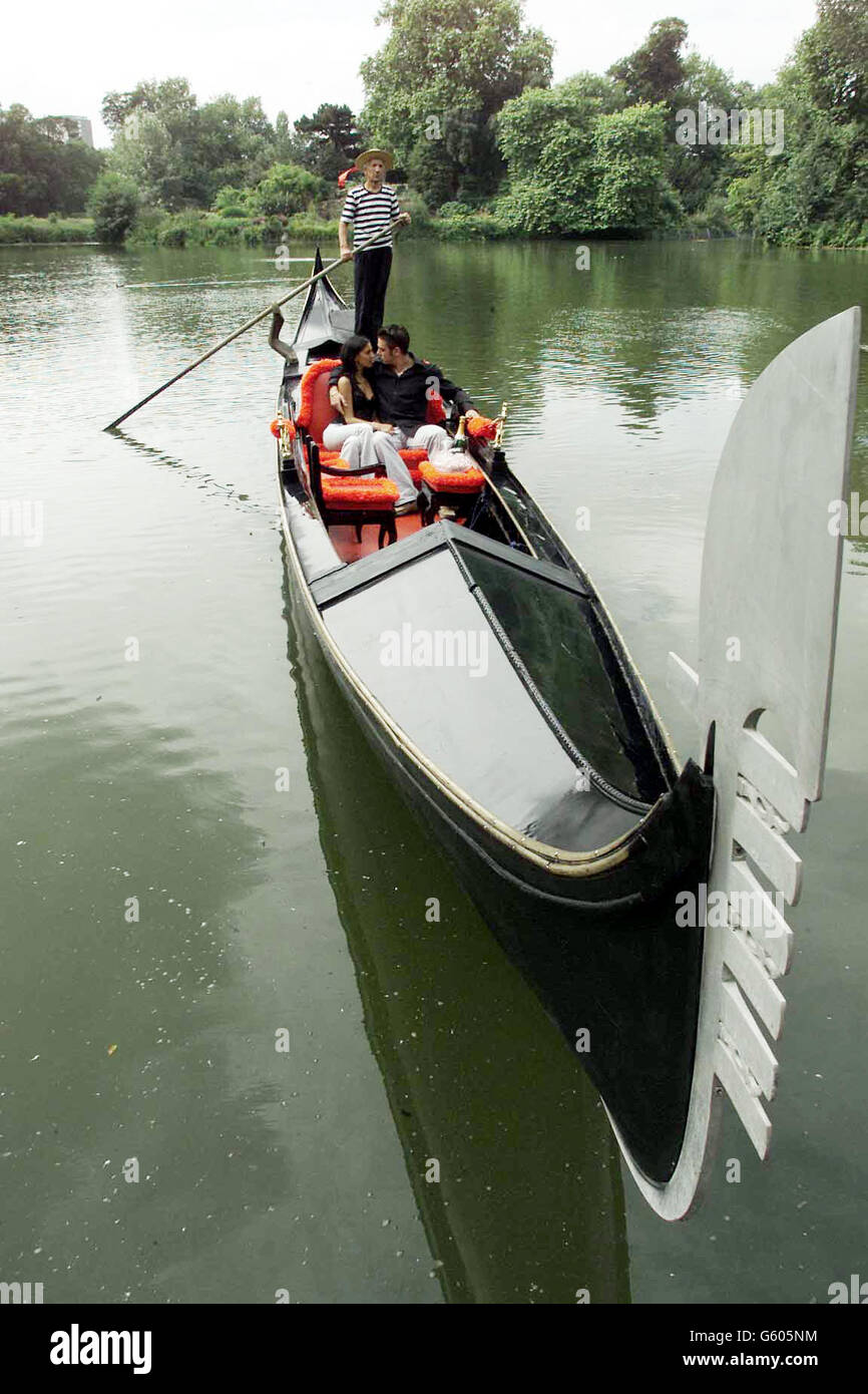 Actress and singer Fyona Wade, star of the ITV teen drama series 24SEVEN, and her boyfriend Sasha, launch an original black Venetian gondola, the only one in England complete with all the fittings, on the lake in Battersea Park. * The 11-metre, six-seater gondola with gold fittings and red cushions will be available to hire on the boating lake along with an authentic Venetian gondolier - Ernesto Vianello. Stock Photo