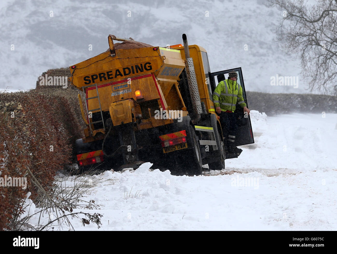 A gritting vehicle waits to be pulled from a ditch near Kippen in Stirlingshire after snowfall. Stock Photo