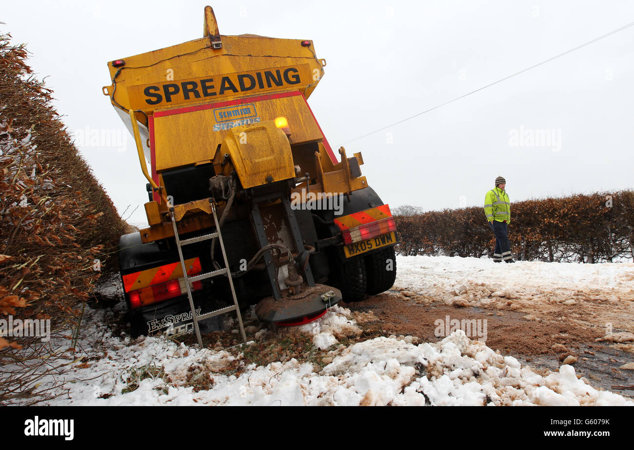 A gritting vehicle waits to be pulled from a ditch near Kippen in Stirlingshire after snowfall. Stock Photo