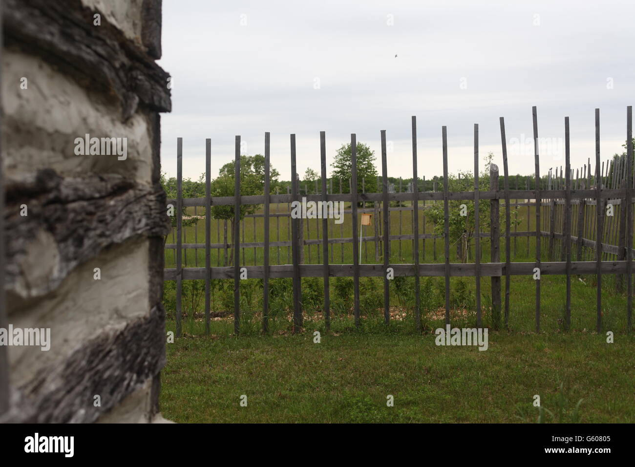 old garden fence with log poles and cabin Stock Photo - Alamy