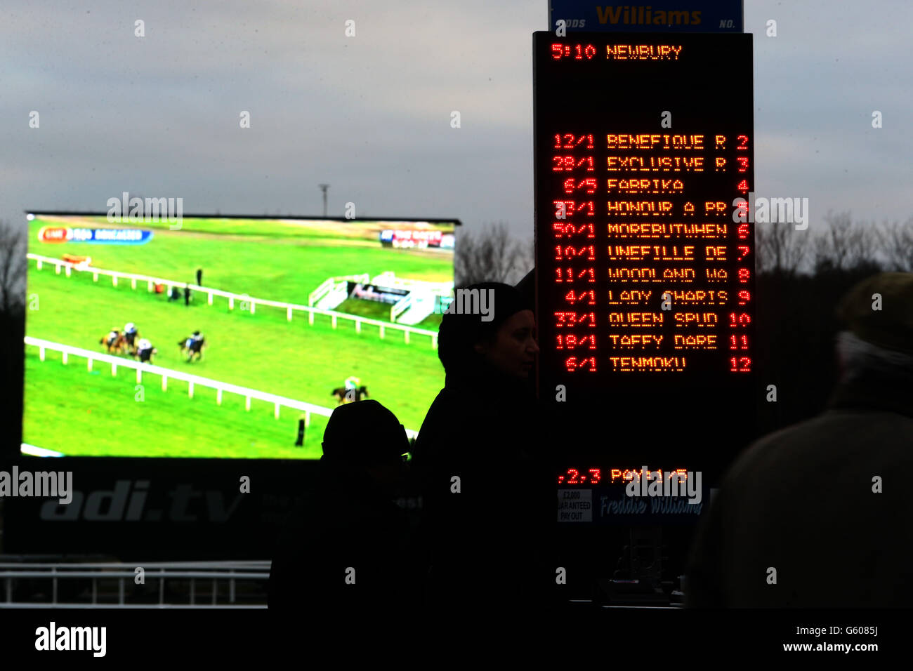 A betting board in front of a giant screen during the Mencap Charity Raceday at Newbury Racecourse, Berkshire. Stock Photo