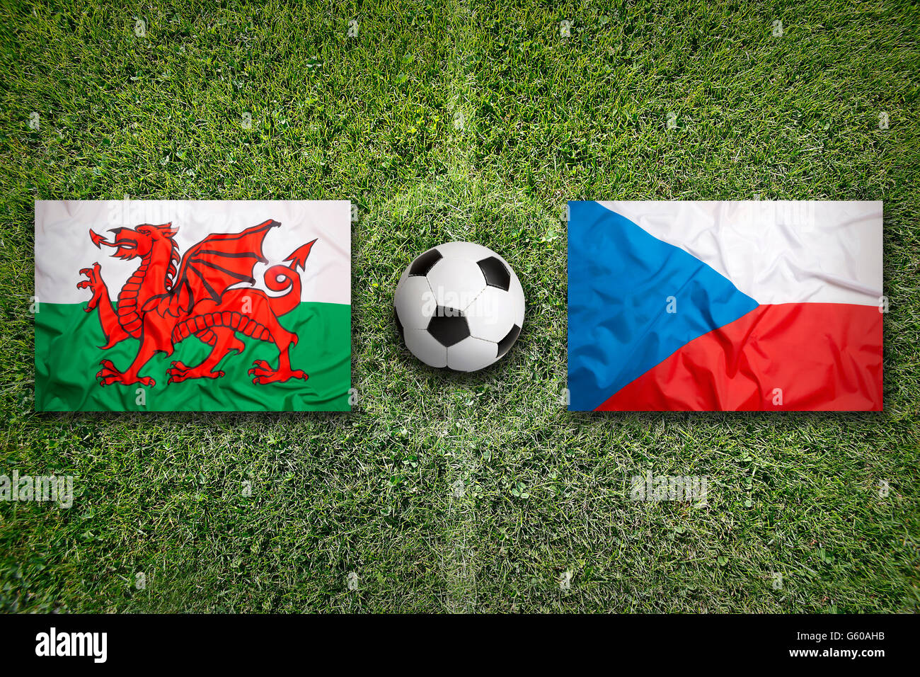 Wales vs. Czech Republic flags on green soccer field Stock Photo