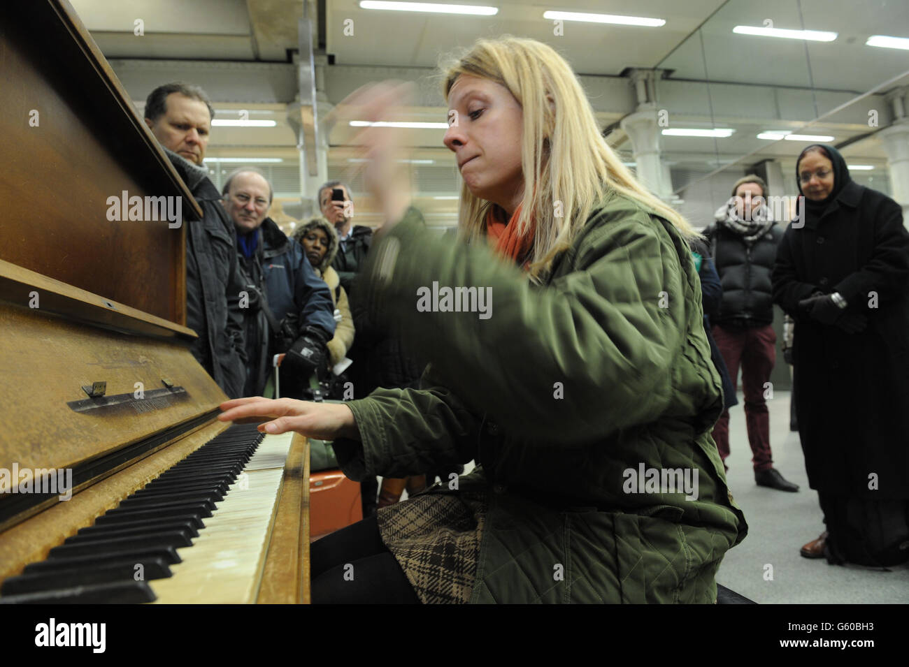 Virtuoso pianist and YouTube star, Valentina Lisitsa, plays to a cluster of commuters on one of the St Pancras' street pianos in the St Pancras Station, London, in the station concourse after her Eurostar train was cancelled due to severe weather conditions affecting the UK and Europe. PRESS ASSOCIATION Photo. Picture date: Tuesday March 12, 2013. Photo credit should read: Nick Ansell/PA Wire Stock Photo