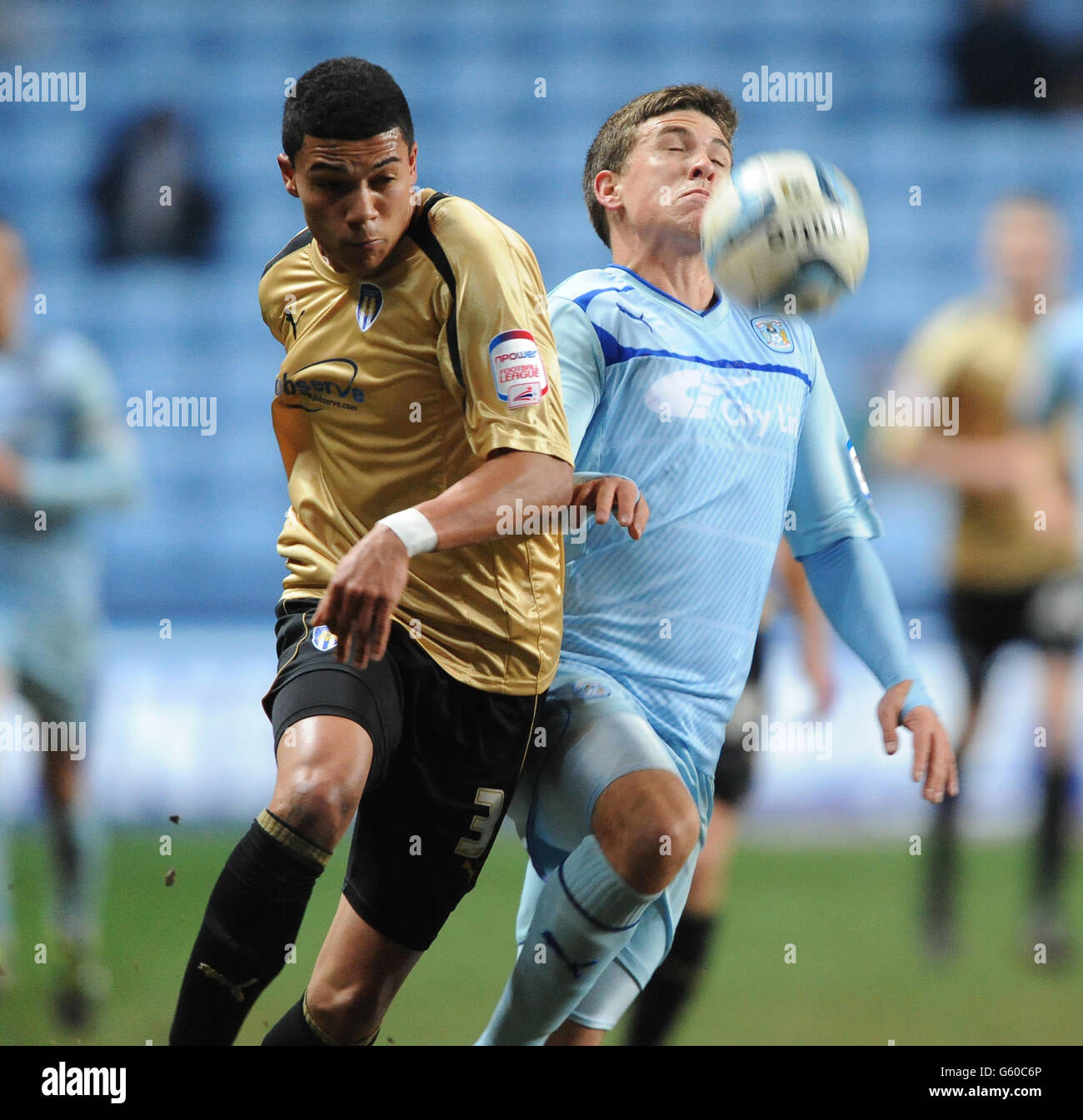 Soccer - npower Football League One - Coventry City v Colchester United - Ricoh Arena. Coventry City's Cody McDonald (right) and Colchester United's Bradley Garmston (left) battle for the ball. Stock Photo