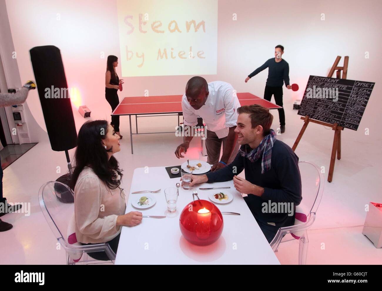 Chef Frederick Forster, centre, serves diners Tom Hills and Farah Hatab during a warm-up ahead of the launch of Steam by Miele, the world's first weight-loss pop-up restaurant in London's Covent Garden. Stock Photo