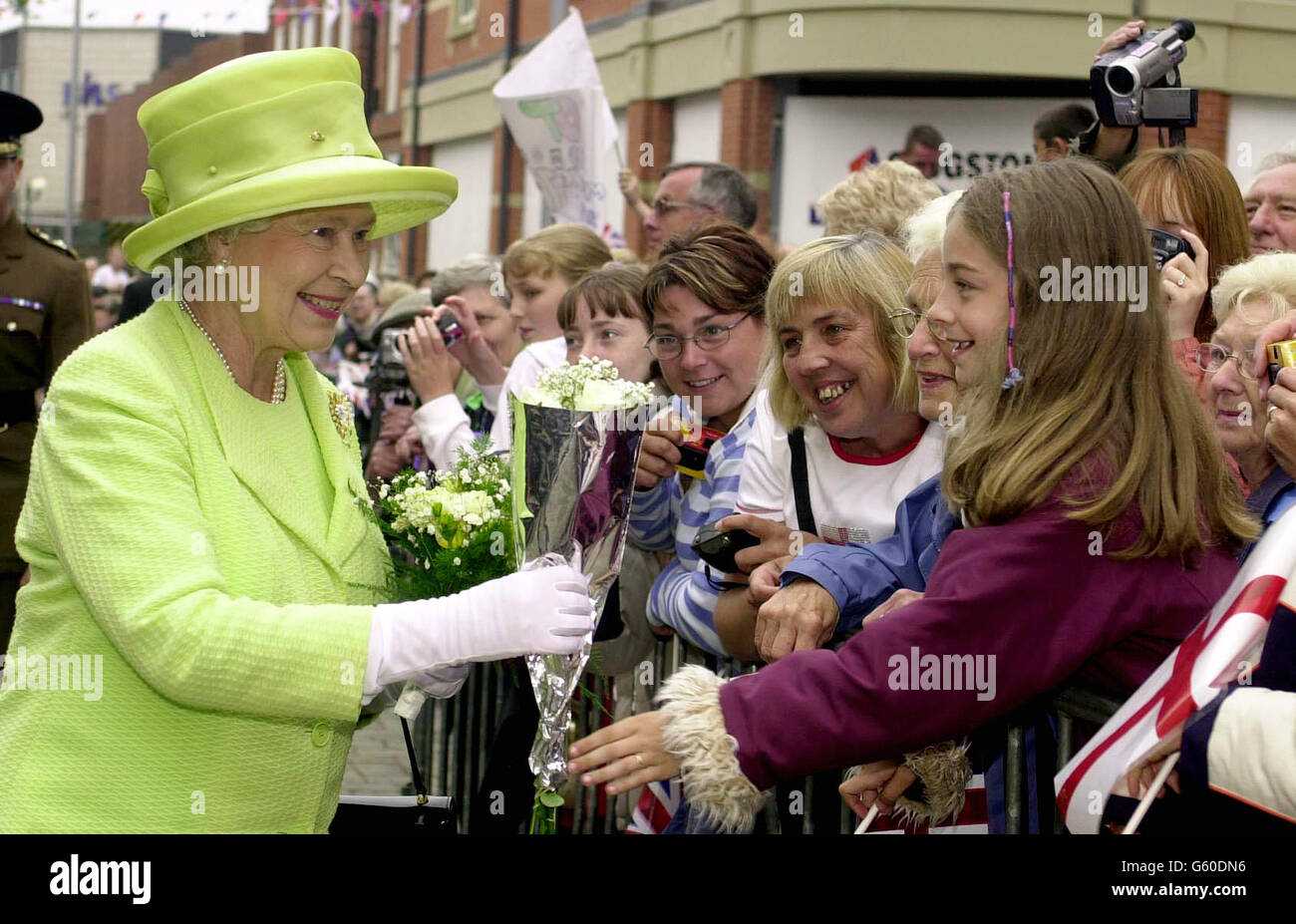 The Queen with flowers in her arms, accepts more bunches as she makes her way down Jubilee walk in Scunthorpe North Lincolnshire, during her Golden Jubilee tour of the area. * Later, the Queen with the Duke of Edinurgh will visit Nottingham, where they are to meet ice dancers Jayne Torvill and Christopher Dean. Stock Photo