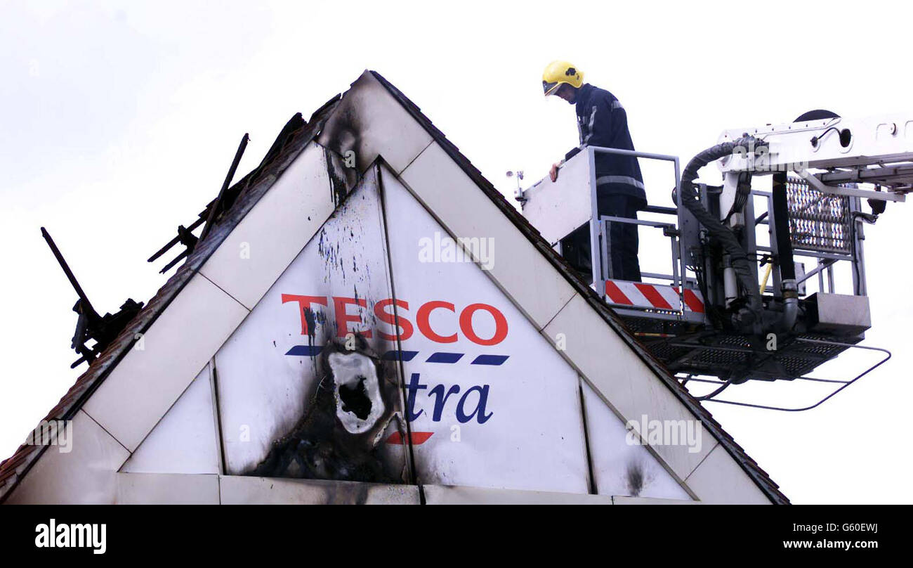Tesco's largest UK superstore in Sandhurst, Berkshire, stands gutted after a fire broke out in the early hours of this morning. Around 100 members of staff fled the 24-hour superstore as the blaze ripped through the warehouse and spread to the shop floor. * destroying over 50% of the shop's roof, the entire warehouse and most of the shop-floor. It was unknown if the fire was caused by arson or by accident, Berkshire fire and rescue service said. Stock Photo
