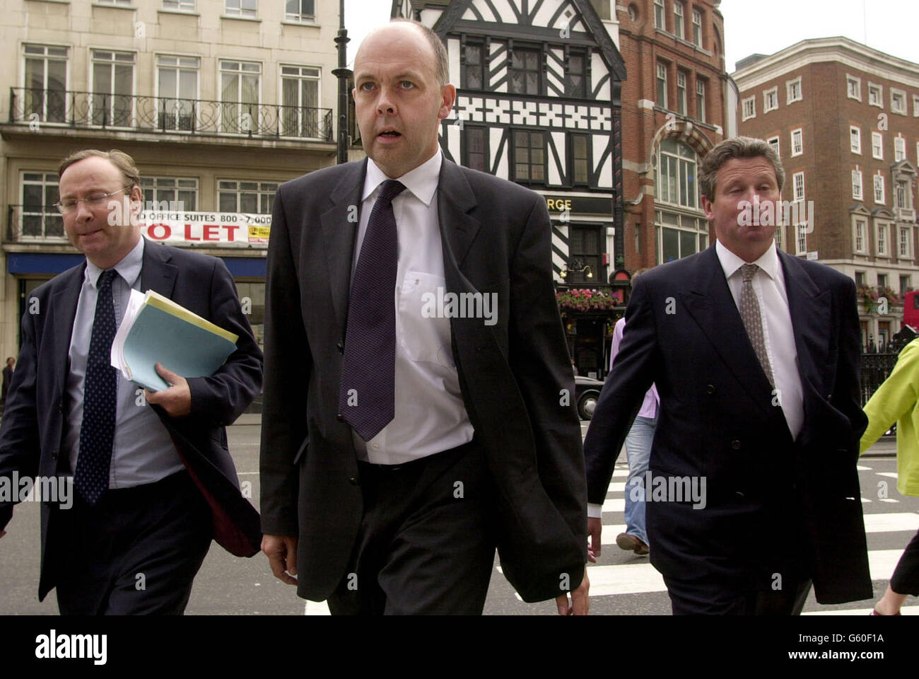 The Chairman of the Football League Keith Harris (right) and his Chief Executive David Burns (centre) arrive at the High Court in central London. *....The Football League's hopes of recovering 178.5 million from Carlton and Granada following the collapse of their joint venture with ITV Digital were dashed when a High Court judge ruled that the media giants were not liable for the channel's debts. 01/08/02 UPDATE Football League clubs were in financial disarray after losing their High Court battle to Carlton and Granada following the collapse of their joint venture ITV Digital. Stock Photo