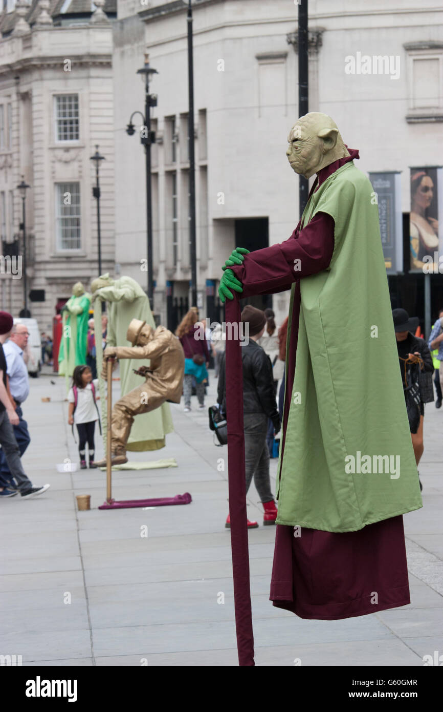 Rows of London street artists performing, floating and levitating trick