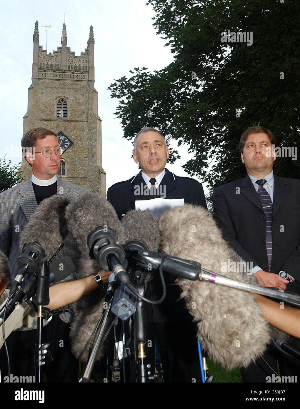 Tim Auban-Jones vicar of St Andrews Church (left), Acting Deputy Chief Constable of Cambridgeshire Police Keith Hoddy (centre) and DCI Andy Hebb present a statement in the town of Soham, Cambridgeshire. *..... where DCC Hoddy announced that the two bodies found in remote fenland at Lakenheath yesterday were 'as certain as we possibly can be' the missing schoolgirls Holly Wells and Jessica Chapman. Stock Photo