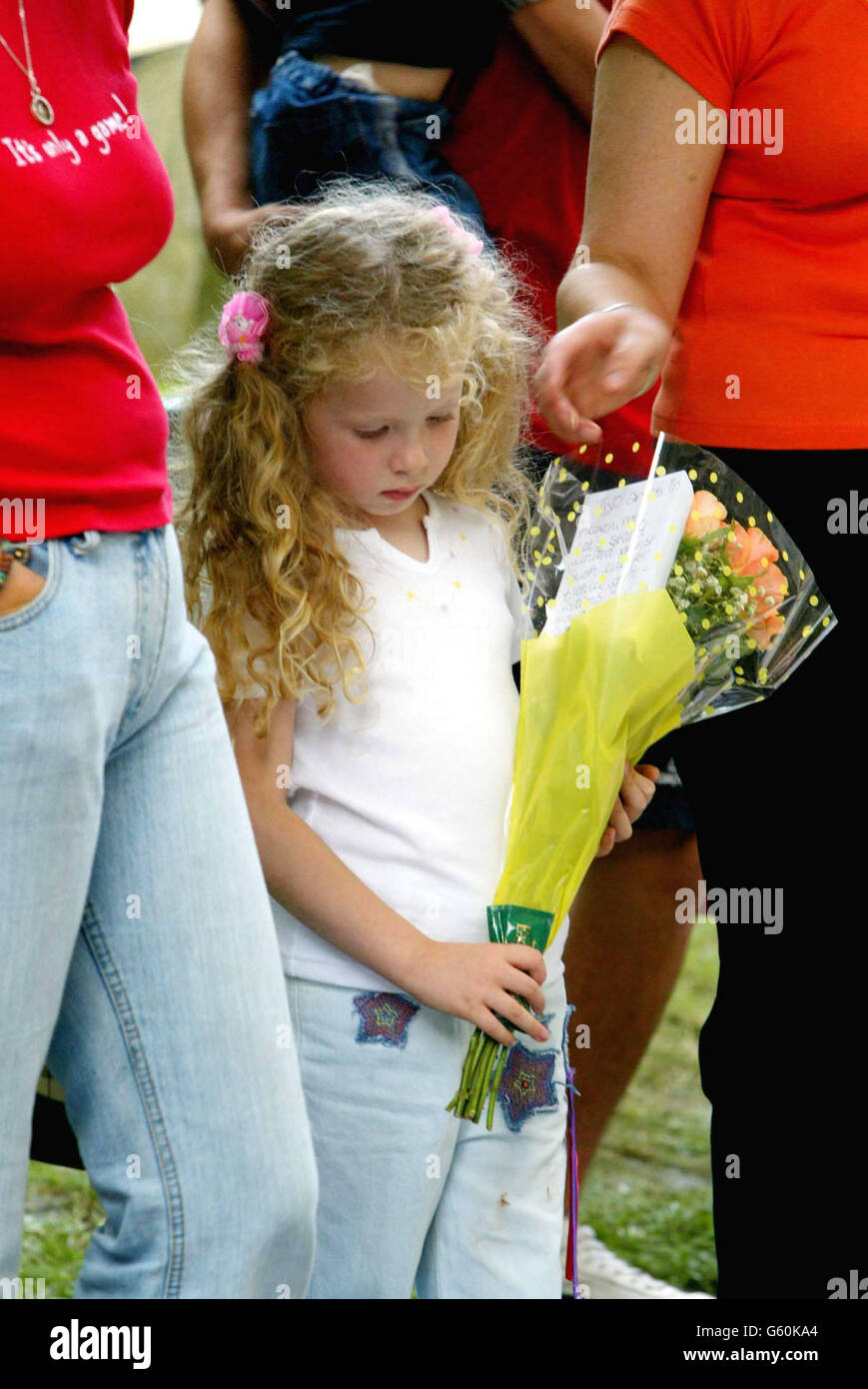 Five-year-old Brittany Gibbs from Derby, lays flowers at St. Andrews Church, Soham, Cambs, for the murdered school girls Holly Wells & Jessica Chapman. Stock Photo