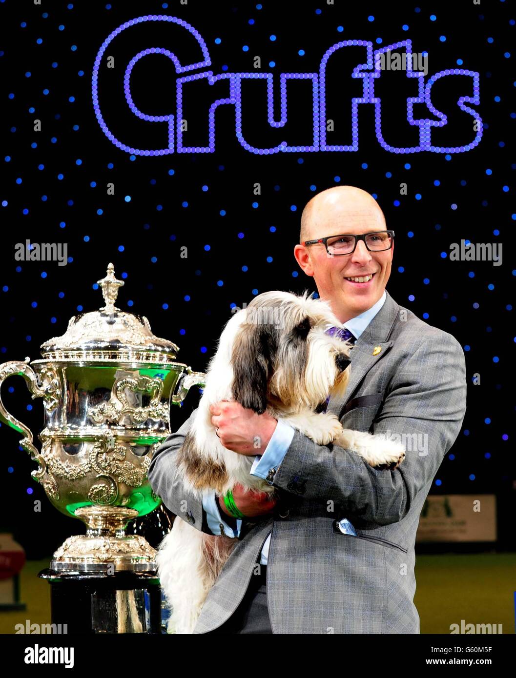 A Petit Basset Griffon Vendeen named Jilly, with owner Gavin Robertson from Wallingford, Oxfordshire, after winning Best in Show at Crufts 2013, NEC, Birmingham. Stock Photo
