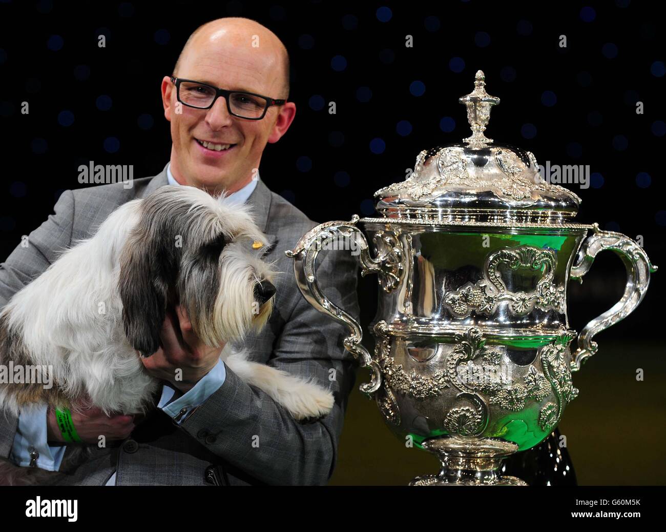 A Petit Basset Griffon Vendeen named Jilly, with owner Gavin Robertson from Wallingford, Oxfordshire, after winning Best in Show at Crufts 2013, NEC, Birmingham. Stock Photo