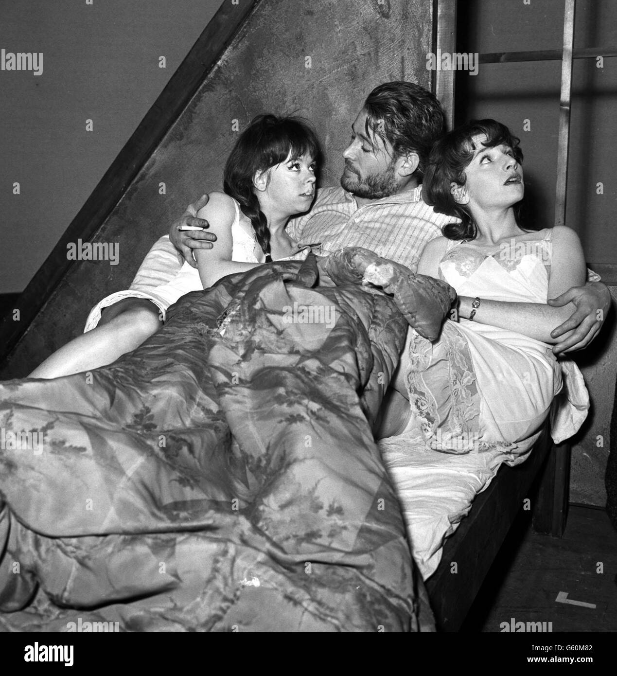 Actor Peter O'Toole in the role of Baal in the Brecht play of the same name, caught in a compromising situation with two sisters played by Kate Binchy (left) and Annette Robinson (right) at The Phoenix during a full dress rehearsal. CELEBRITY Stock Photo