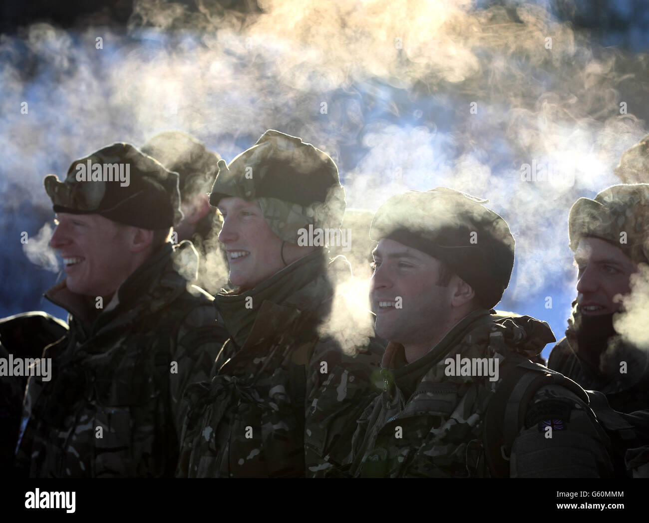 Marines watch the Skijoring drill which involves marines being towed behind the BV-206 vehicle during Exercise Hairspring 2013 which focuses on cold weather survival and warfare training for Royal Marines Commando Reservists in the mountains range near to Porsanger Garrison near Lakselv,Norway. Stock Photo