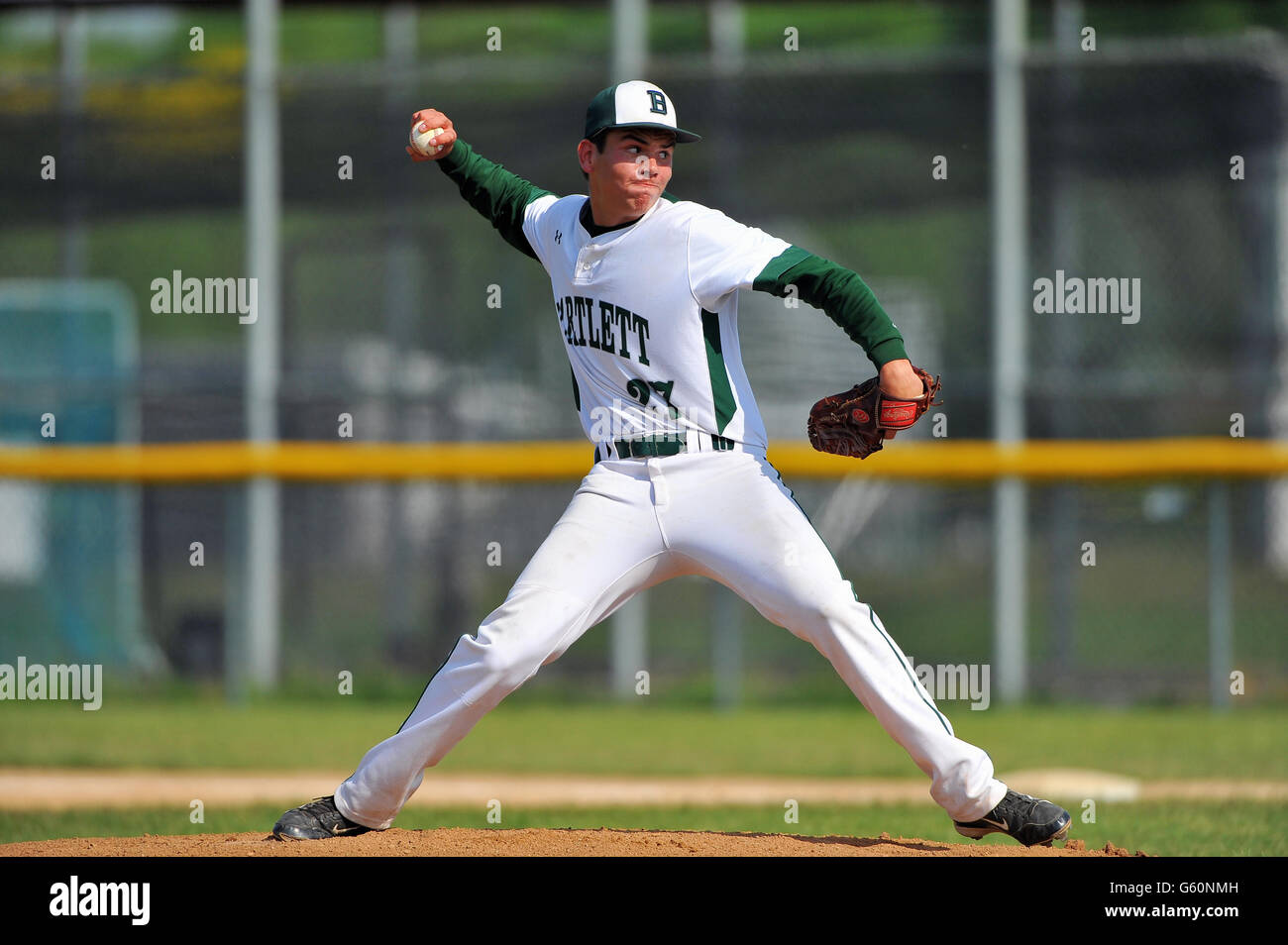 Righthanded pitcher delivering a pitch to a waiting hitter during a