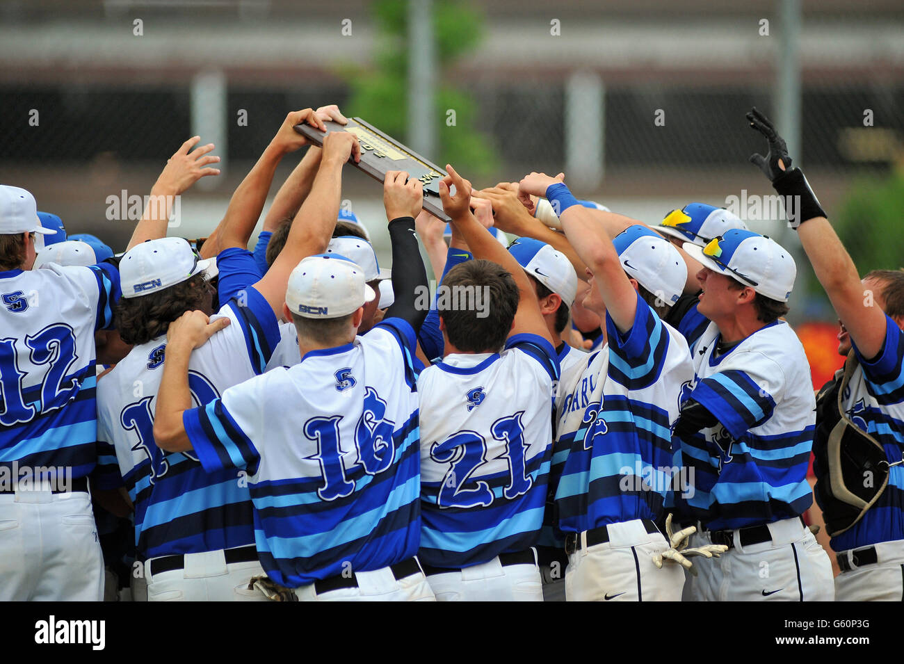 Players rally around a sectional championship plaque they has just won with an on-field victory. USA. Stock Photo