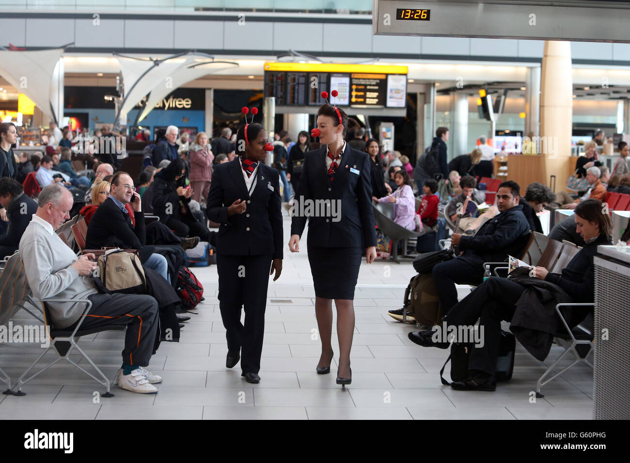 British Airways stewardesses wear red noses in aid of Comic Relief in Terminal 5 of Heathrow Airport. Stock Photo