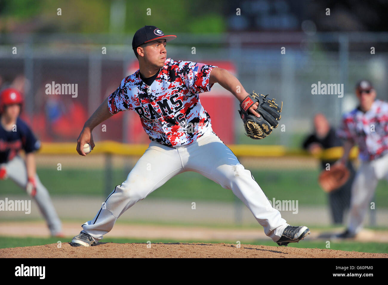 Righthanded pitcher delivering a pitch to a waiting hitter during a