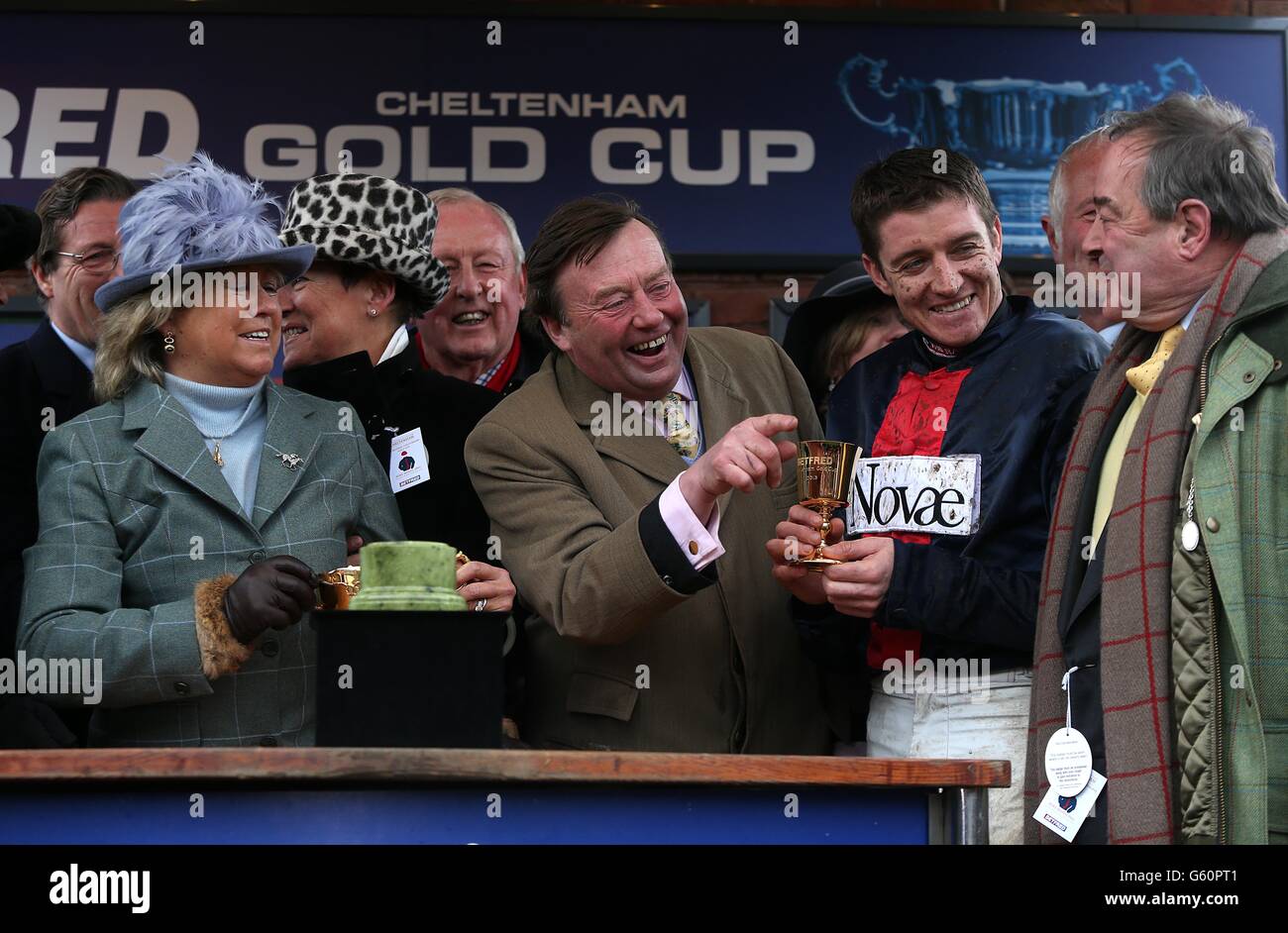 Winning Trainer Nicky Henderson (centre) and Jockey Barry Geraghty (second from right) collect their trophy after winning the Betfred Cheltenham Gold Cup Chase with Bobs Worth during Cheltenham Gold Cup Day, at the Cheltenham Festival. Stock Photo