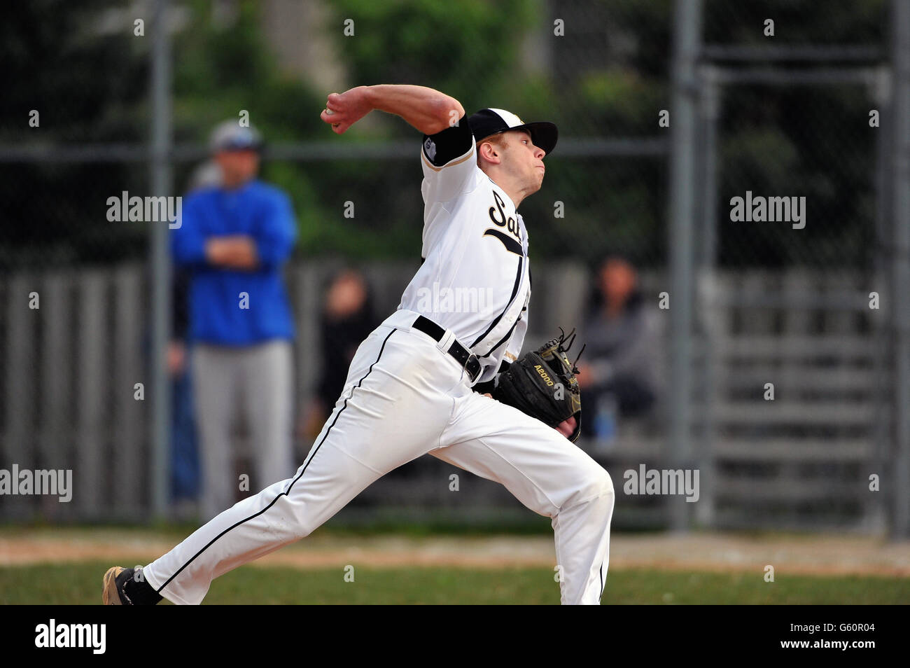 Righthanded pitcher delivering a pitch to a waiting hitter during a