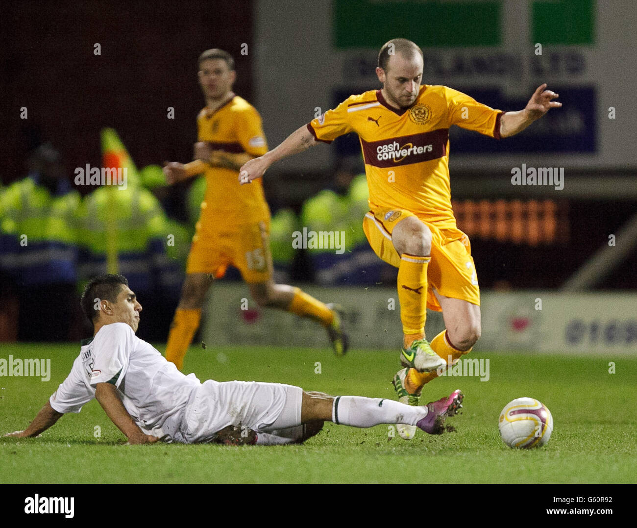 Motherwell's James McFadden is tackled by Hibernian's Jorge Claros during the Clydesdale Bank Scottish Premier League match at Fir Park, Motherwell. Stock Photo